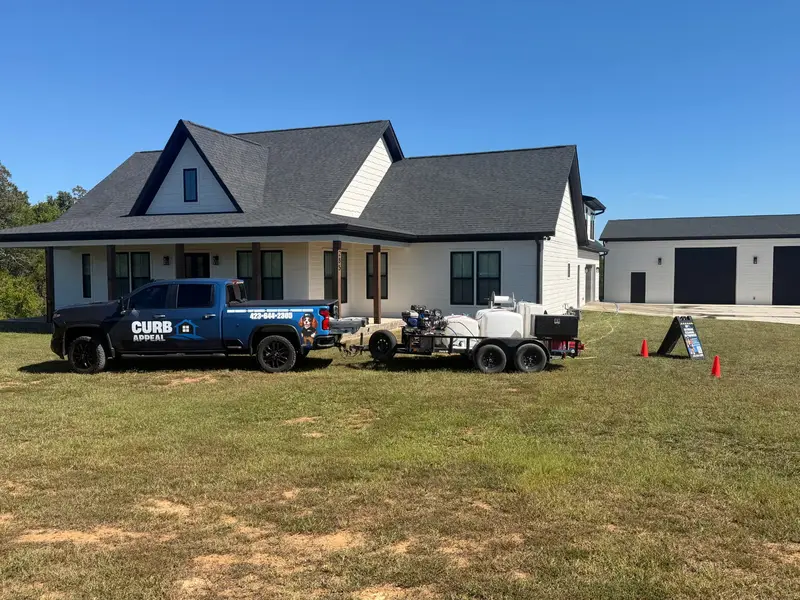 Curb Appeal truck and exterior cleaning equipment outside a home